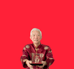 Asian senior man give gold pig sculpture for Chinese new year boar year