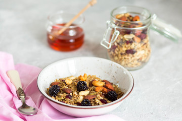 Granola with yogurt, honey and berries. Breakfast with berries and nuts. The correct breakfast. Delicious dish in the morning