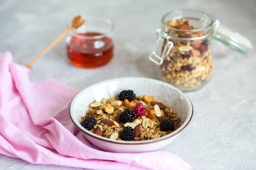 Granola with yogurt, honey and berries. Breakfast with berries and nuts. The correct breakfast. Delicious dish in the morning