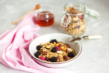 Granola with yogurt, honey and berries. Breakfast with berries and nuts. The correct breakfast. Delicious dish in the morning