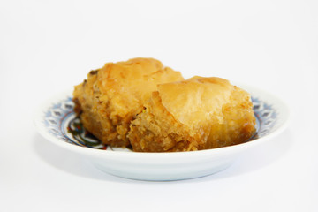 traditional Turkish baked sweetness baklava with honey on colorful plate
