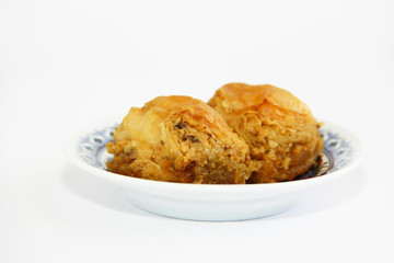 traditional Turkish baked sweetness baklava with honey on colorful plate