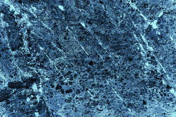 Vintage blue background. Rough painted wall of sapphire color. Imperfect plane of blue colored. Uneven old decorative toned backdrop of cyan tint. Texture of sapphirine hue. Ornamental stony surface.