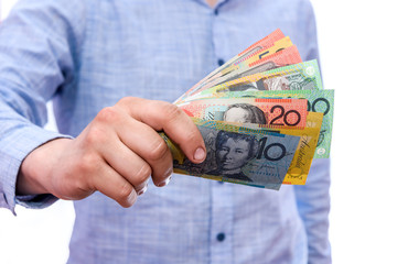Male hands showing australian dollar banknotes close up