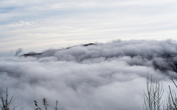 Aerial view of mountains engulfed in clouds