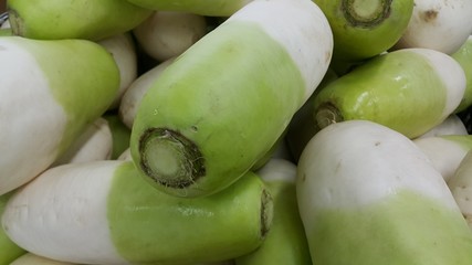 Vegetable background: Large radish pile in supermarket.
