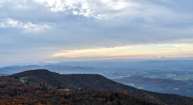 Aerial twilight panorama of mountain forests in autumn colors