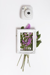 Bunch of flowers and photo frame near camera