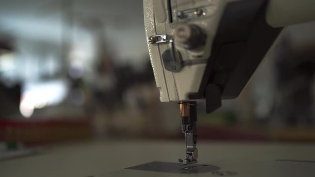 Sewing machine niddle close up with bokeh creamy background
