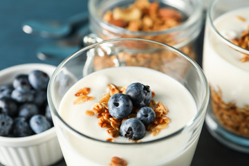 Composition with parfaits desserts on dark blue background, closeup