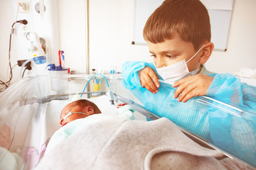 Little boy with premature infant brother, hospital
