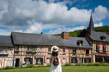 Woman is traveling at destination in Northern vintage old town village in Normandie district in...