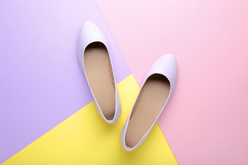 Purple female shoes on colorful background