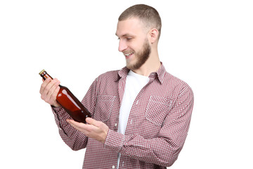 Young man with bottle of beer on white background