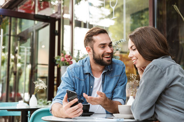 Attractive young couple in love having lunch - Powered by Adobe