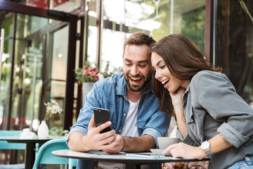 Attractive young couple in love having lunch