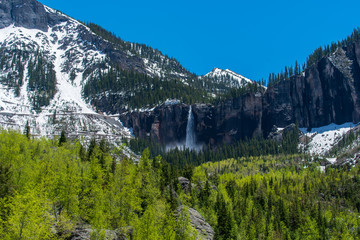 Telluride, Colorado low angle landscape of bridal veil falls, aspen trees and mountain peaks