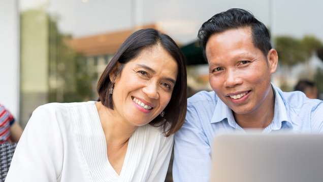 Close Up On Asian Couple Lover Smiling With Happy Feeling At Outside Department Store In Weekend Day And , Mature Love Relationship Concept