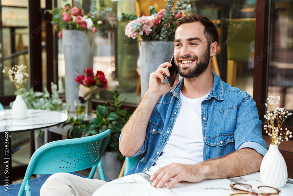 Sticker handsome smiling man sitting at the cafe table