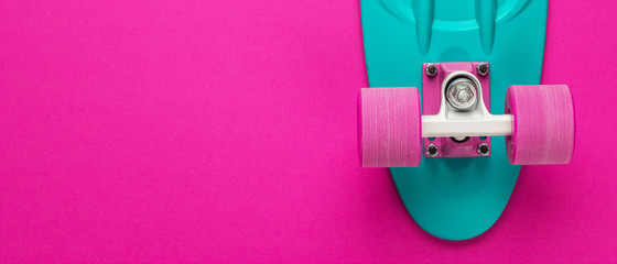 mini cruiser board on deep pink back