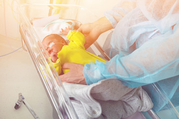 Close-up portrait of infant in father's hands