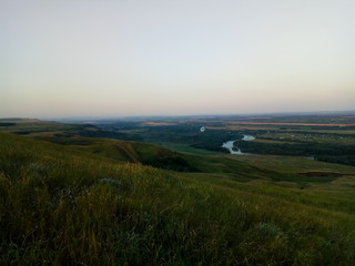 sunset over green field