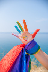 Hand with the pride flag and its colors