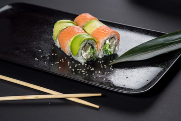 Sushi roll philadelphia on black background. Sushi menu. Japanese food.