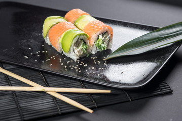 Sushi roll philadelphia on black background. Sushi menu. Japanese food.