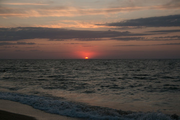 The setting sun going beyond the horizon of the Azov sea