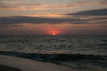 The setting sun going beyond the horizon of the Azov sea