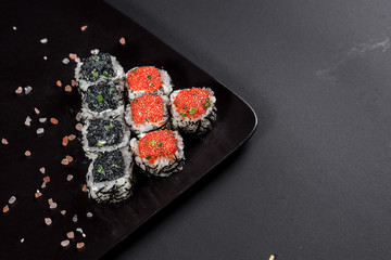 Sushi with caviar on black