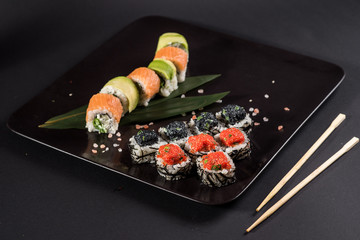 Sushi with caviar on black