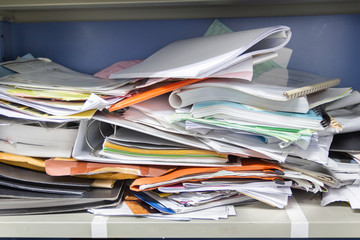 Messy file document and Office Supplies in filing cabinets at work office