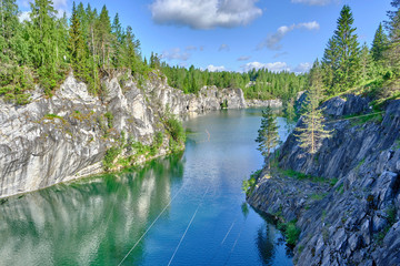 Scenic view of abandoned flooded marble mine in Ruskeala national park in Karelia. Beautiful summer sunny look of popular touristic canyon on the North of Russian Federation