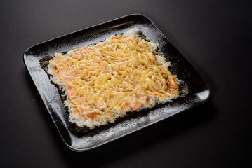 Sushi pizza on black