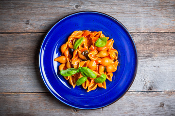 Fresh pasta with sausages, olives and basil leaves. Selective focus. Shallow depth of field.