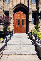 Maple antique wooden entrance door of an historical house in Montreal, Canada