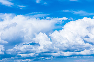 The vivid sky or heaven background with white and blue clouds under the sun rays