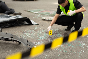 Close-up of policeman working at car accident area