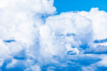 The vivid sky or heaven background with white and blue clouds under the sun rays