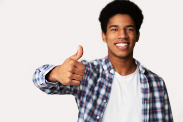 Naklejka premium I Recommend It. Overjoyed Afro Guy Showing Thumb Up