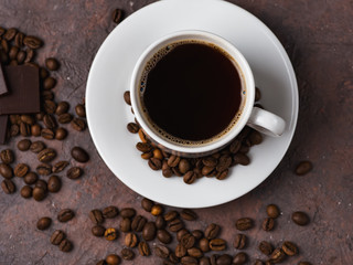 White Cup with espresso coffee on a brown stone table