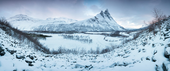 Fototapeta na wymiar Beautiful landscape scene with Signaldalelva river and Otertinden mountain in background in Northern Norway . Sunset or sunrise in Mountains And Fjords, Winter Landscape.