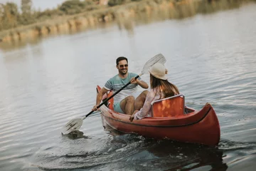 Foto op Canvas Loving couple rowing on the lake © BGStock72