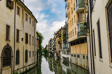 Fototapeta na wymiar Water channel San Massimo runs among residential houses in the centre of the old city Padua, Italy