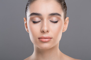 Portrait of beautiful woman with clean skin and closed eyes