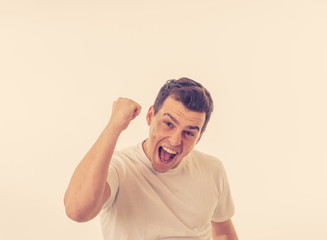 Close up portrait of happy successful man celebrating winning and victory looking amazed