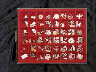 Old wooden drawer lined with red velvet, with many compartments, filled with old  jewelry pendants