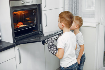Child in a kitchen. Little brothers prepare the lunch